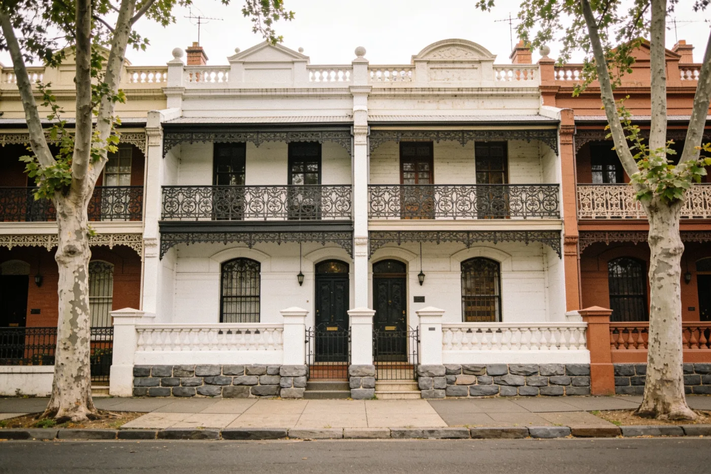 A row of Victorian terrace houses with cast-iron lacework in inner Melbourne